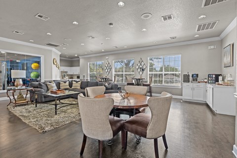 A modern dining room with a table set for two.