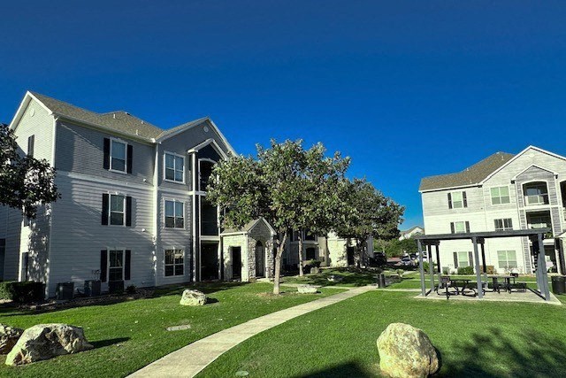 a group of houses with a yard and grass