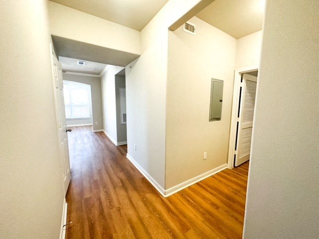 a room with a hard wood floor and white walls
