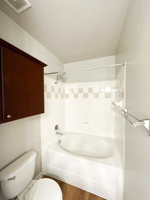 a white bathroom with a toilet and a sink