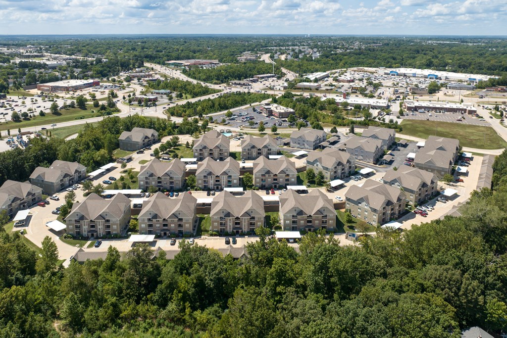 A bird's eye view of a residential area with houses surrounded by trees at Bramblett Hills Luxury Apartments in O Fallon MO 63366