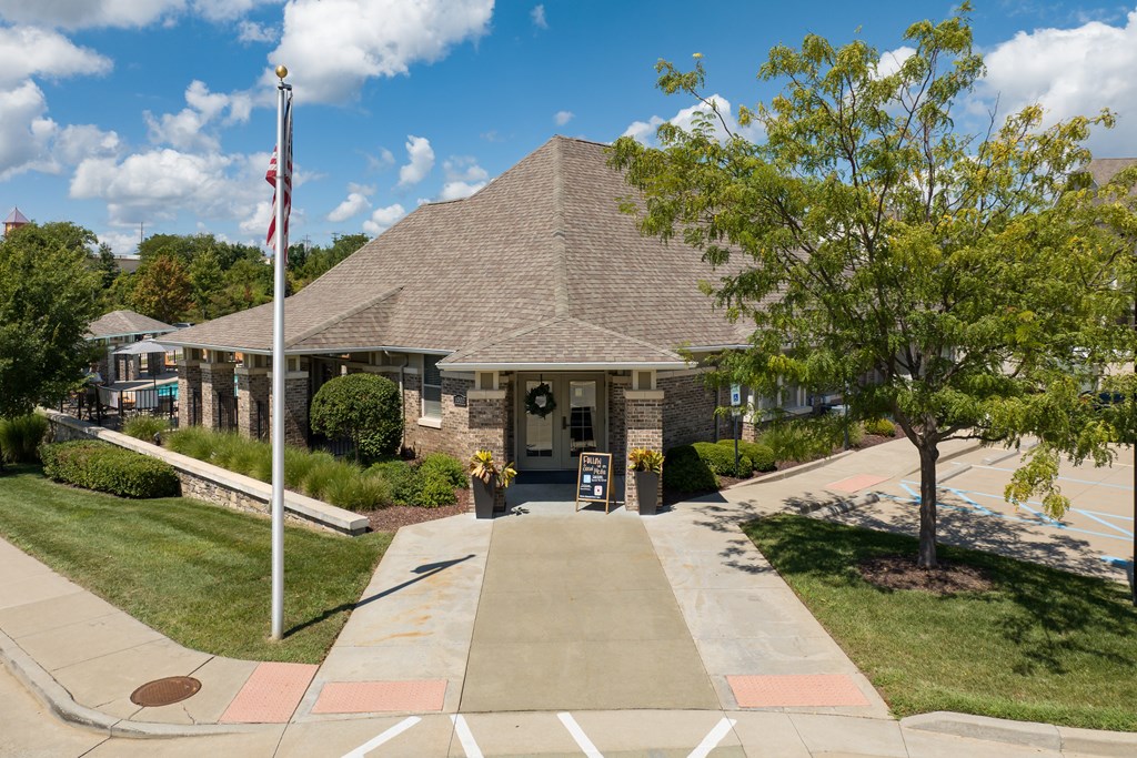 A building with a flag on a pole in front of it at Bramblett Hills Luxury Apartments in O Fallon MO 63366