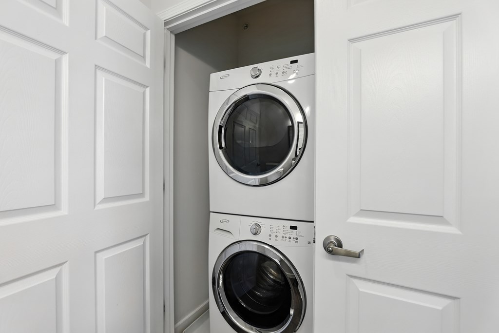 Two washing machines are stacked in a small space at Bramblett Hills Luxury Apartments in O Fallon MO 63366