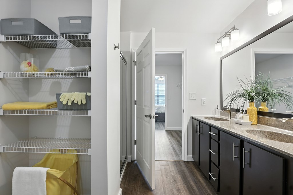 A bathroom with a mirror, sink, and towel at Bramblett Hills Luxury Apartments in O Fallon MO 63366