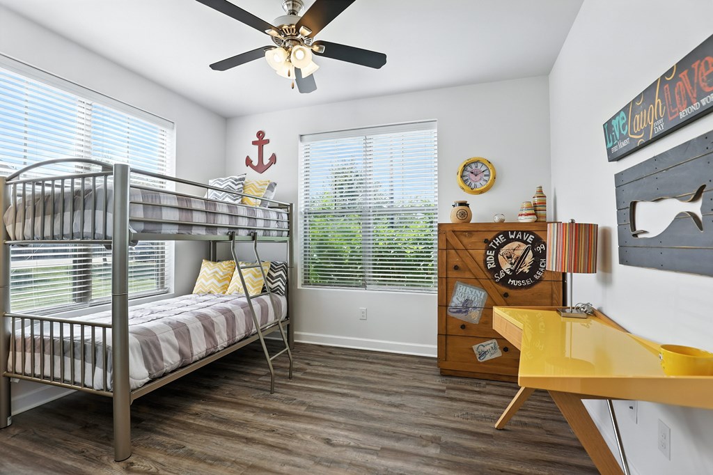 A room with a bunk bed and a desk at Bramblett Hills Luxury Apartments in O Fallon MO 63366