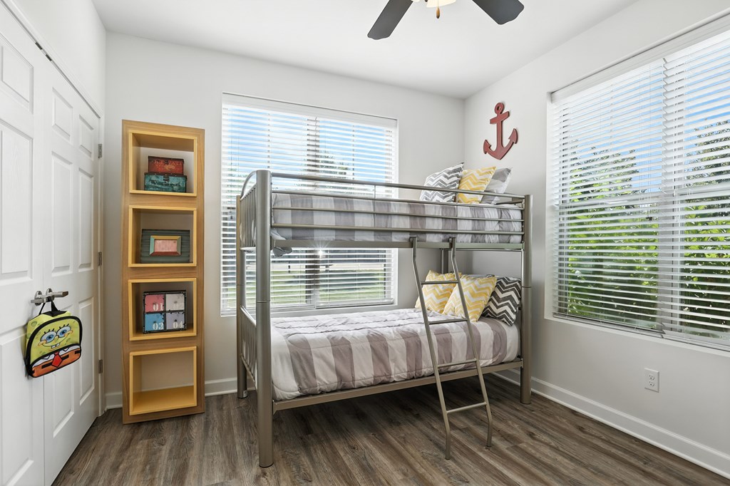A room with a bunk bed and a bookshelf at Bramblett Hills Luxury Apartments in O Fallon MO 63366
