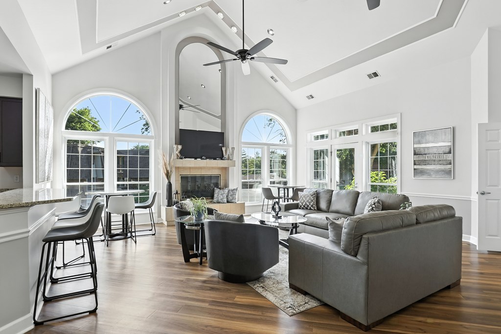 A modern living room with a grey sofa and a bar area.