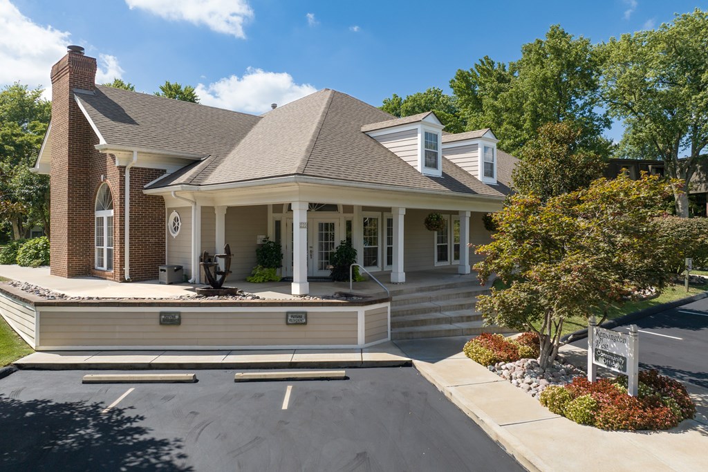 A house with a brick chimney and a porch.