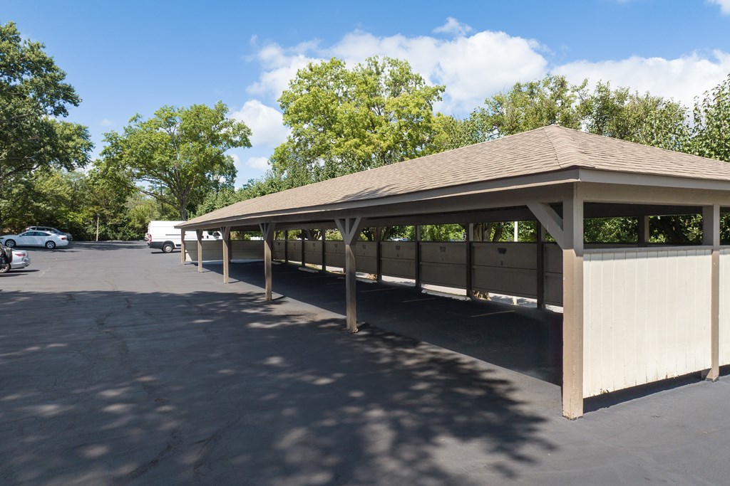 A large covered parking area with a concrete floor.
