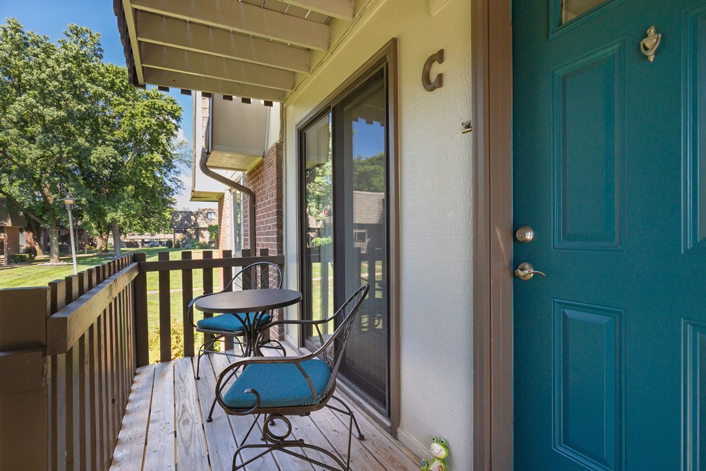 A blue chair is on a wooden deck.