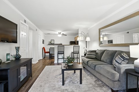 A living room with a grey couch and a wooden coffee table.
