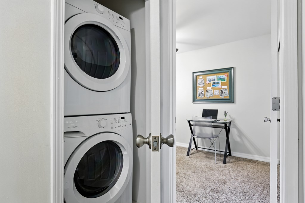 A white washing machine is in a doorway.