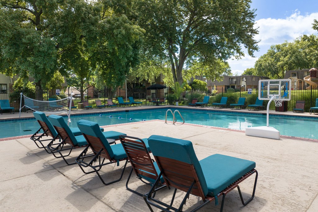 A pool with chairs around it.