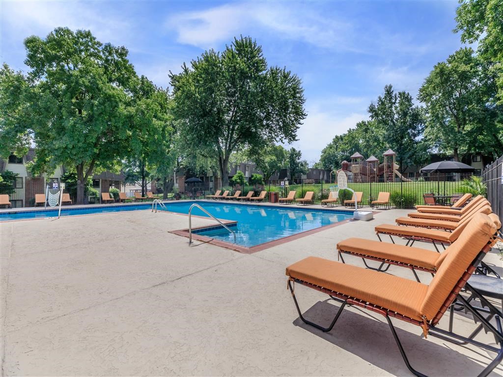 the swimming pool at our apartments has a pool and lounge chairs