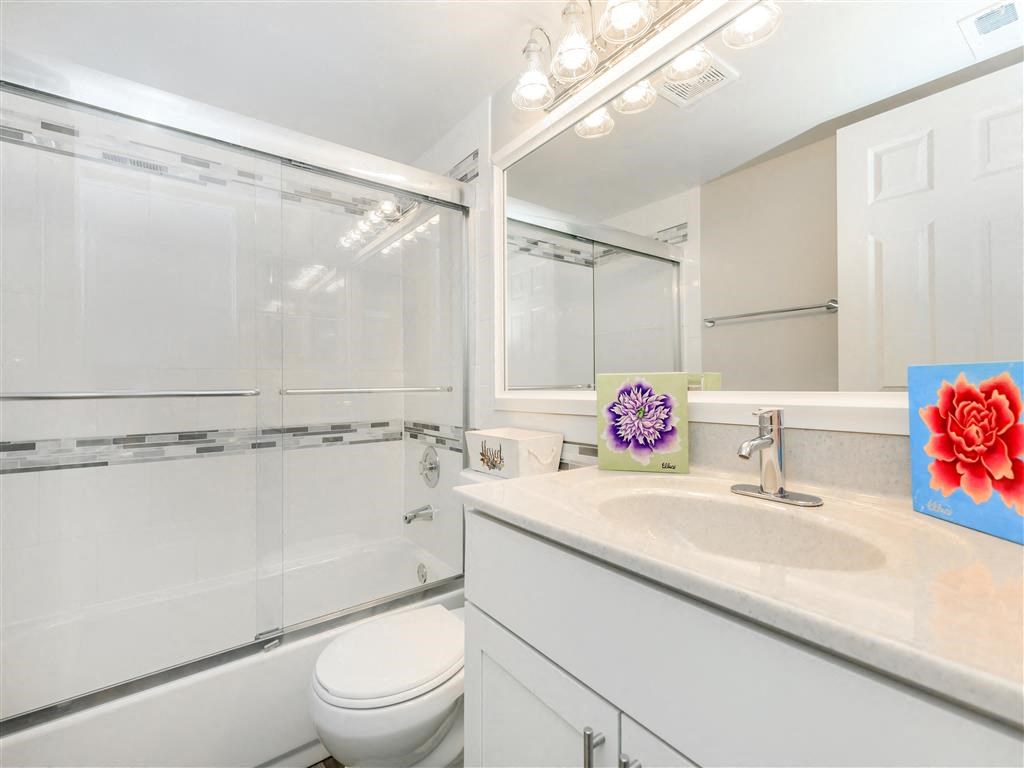 a bathroom with a sink toilet and a shower