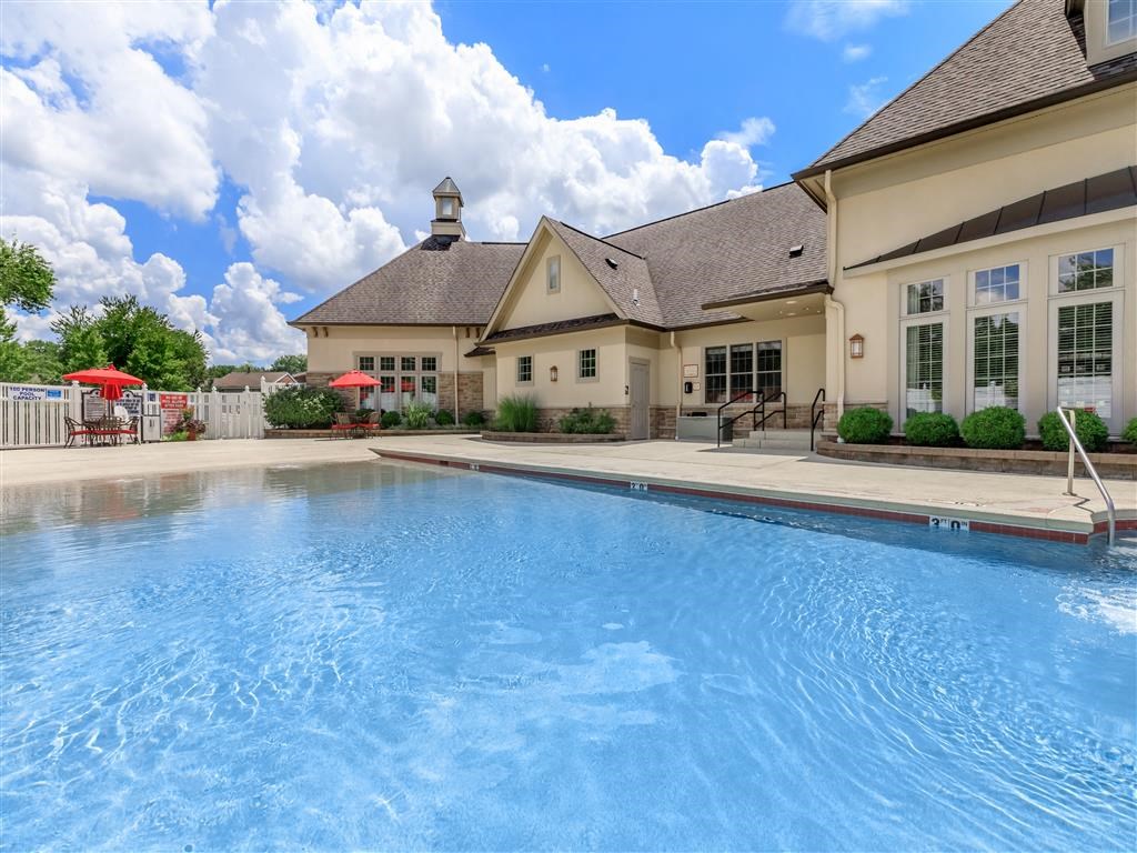 a large swimming pool with a building in the background