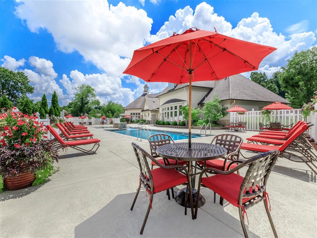 our apartments have a large patio with tables and chairs and a pool