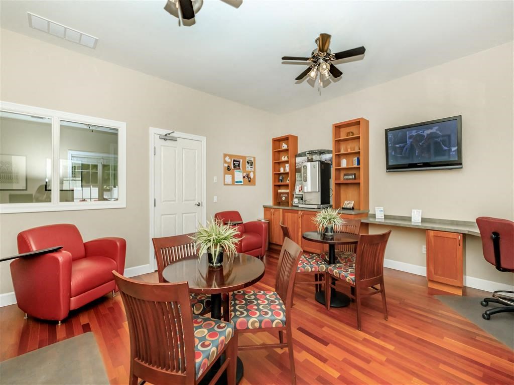 a living room and dining room with a table and chairs