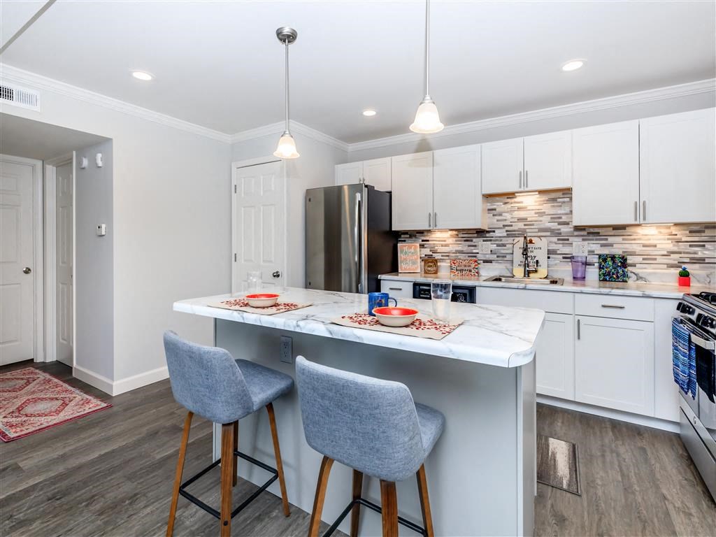 a kitchen with an island and two stools
