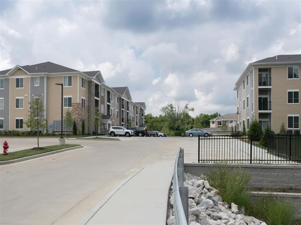 an empty parking lot in front of an apartment building
