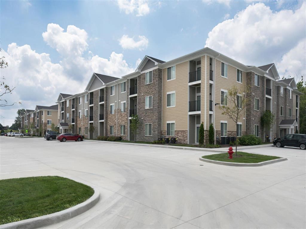 an apartment building with a red fire hydrant in front of it