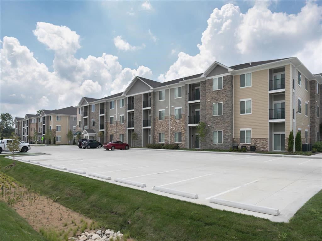 an empty parking lot in front of an apartment building
