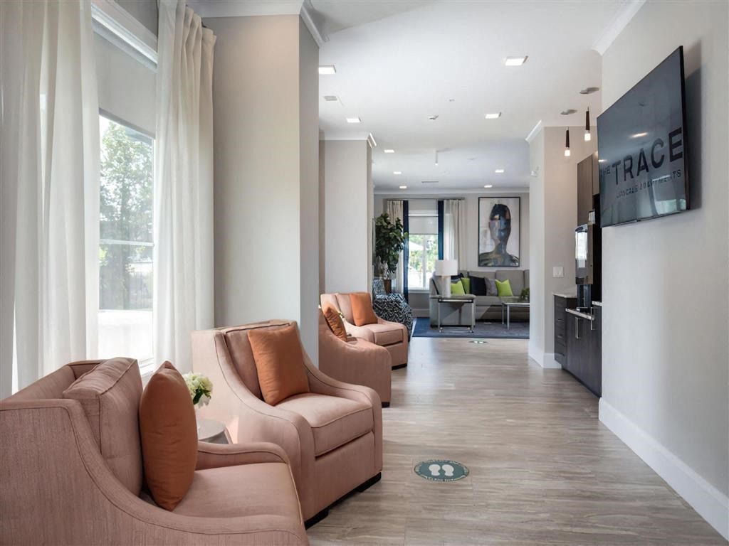 a living room with couches and chairs and a tv