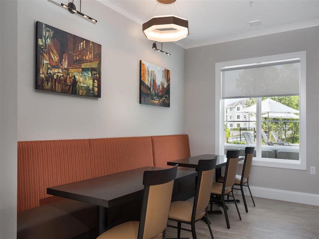 a dining room with tables and chairs and a large window