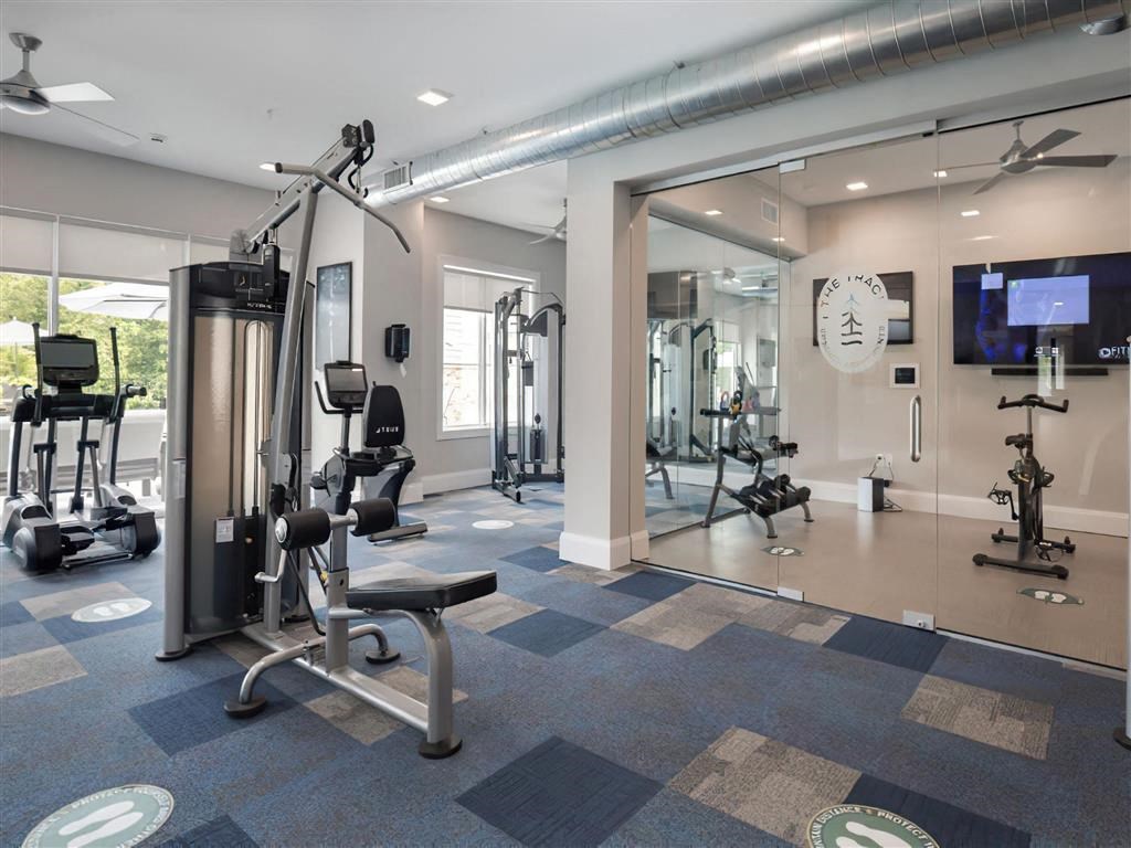 a gym with weights and other equipment in a building