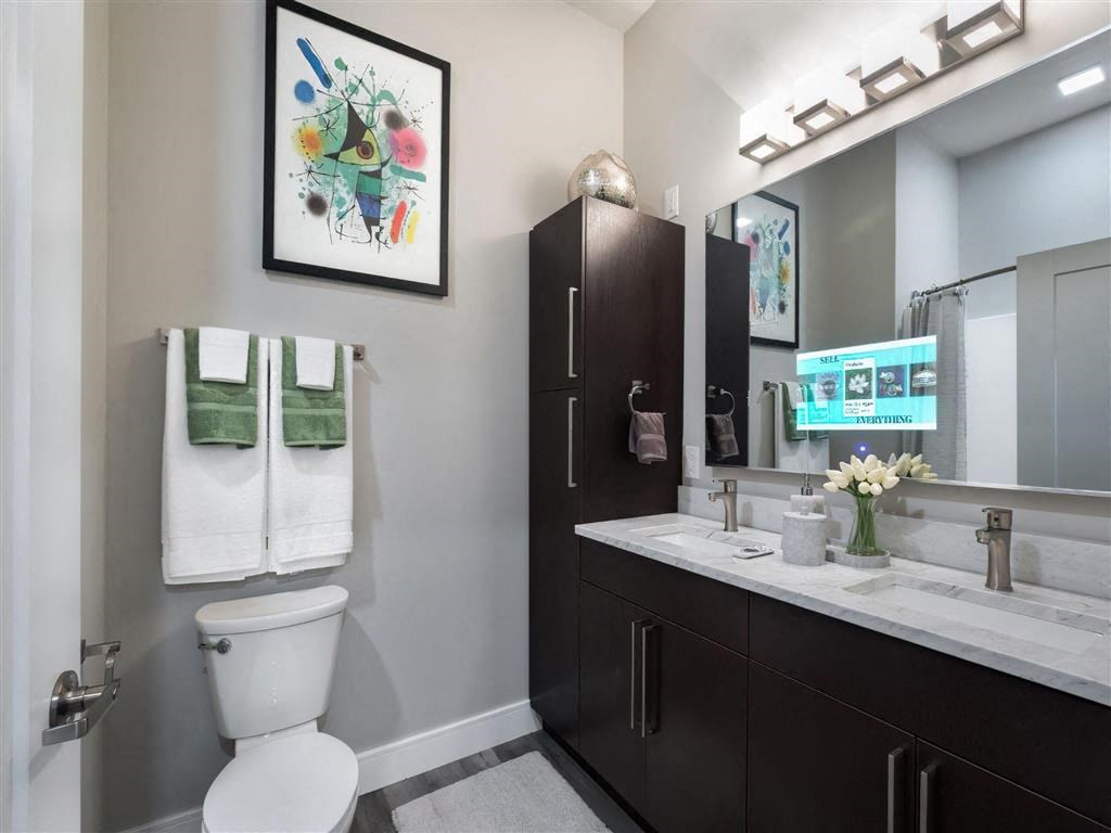 a bathroom with a toilet and a sink and a mirror