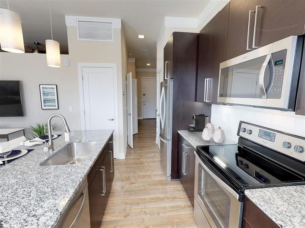 a kitchen with granite counter tops and stainless steel appliances