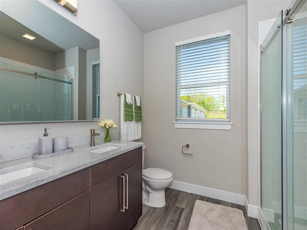 a bathroom with a toilet and a large mirror