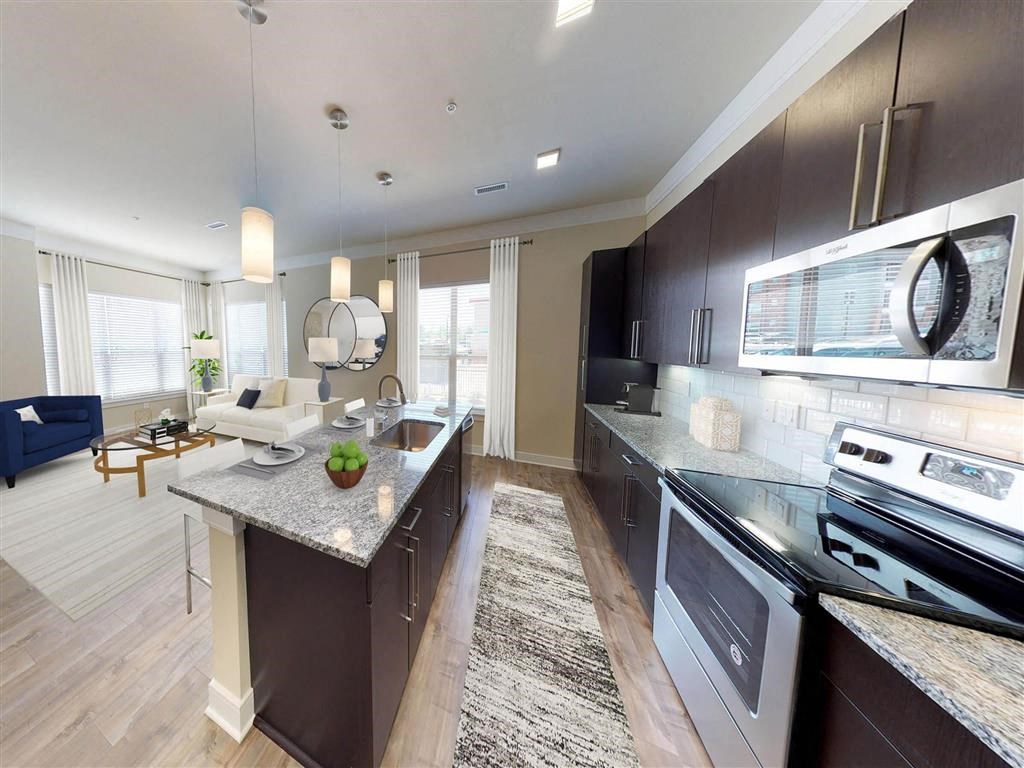 a kitchen and living room with a counter top