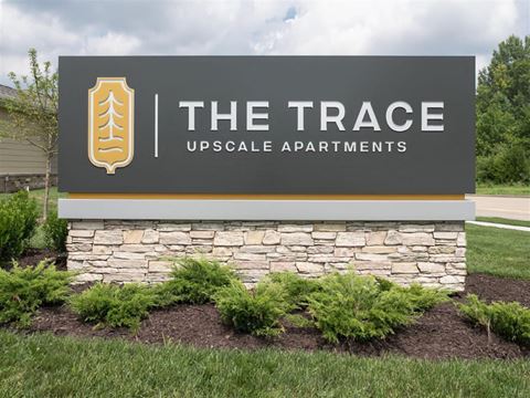 a sign for the race upscale apartments is shown in front of a grass field