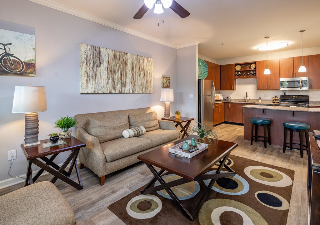 A living room with a couch, a coffee table, and a painting on the wall.