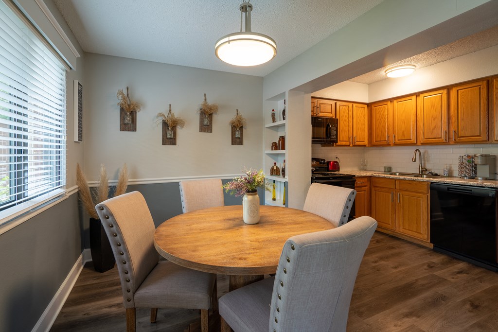 a dining room with a table and chairs and a kitchen