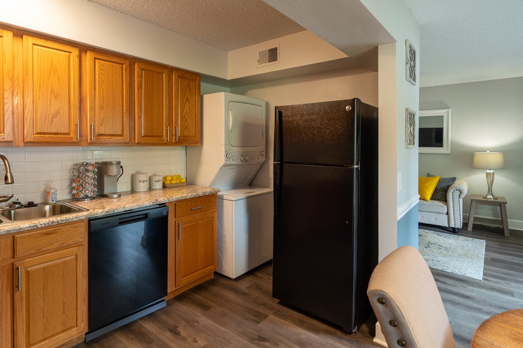 a kitchen with a refrigerator and a sink and a refrigerator