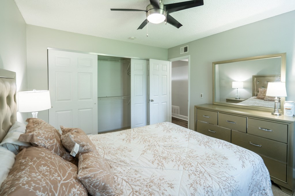 a bedroom with a large bed and a closet