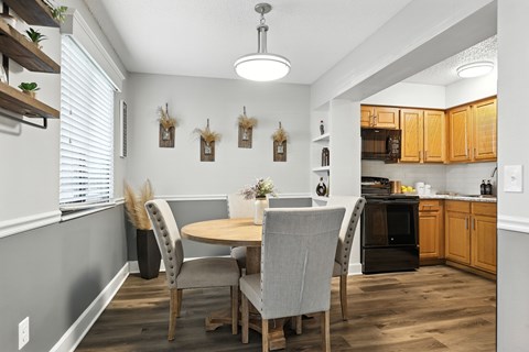 A kitchen with a table and chairs in the middle of the room.