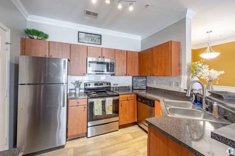 A kitchen with wooden cabinets and stainless steel appliances.