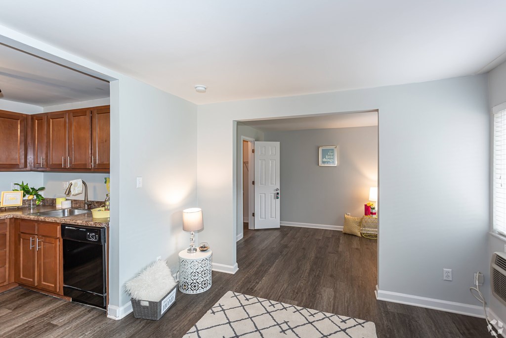 A kitchen with wooden cabinets and a black oven.