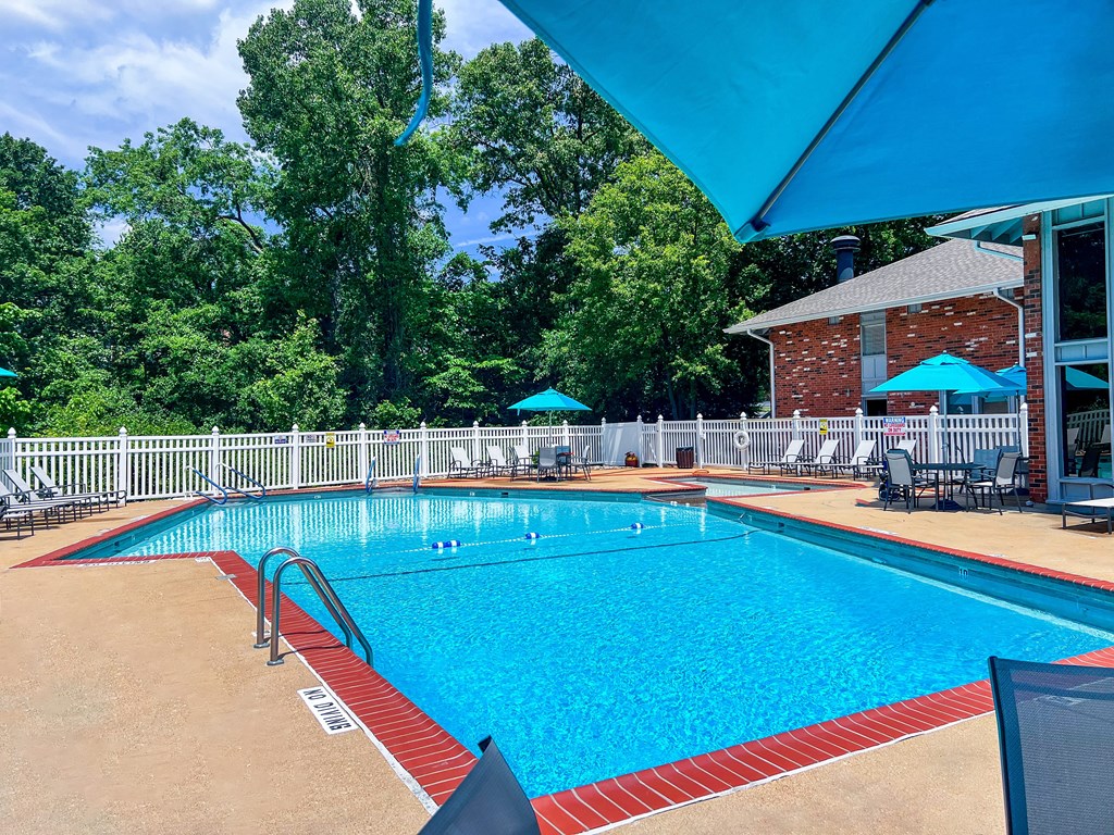 A large outdoor swimming pool with a red and white border.
