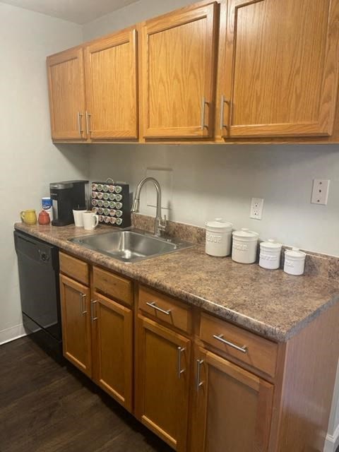 a kitchen with wooden cabinets and a sink