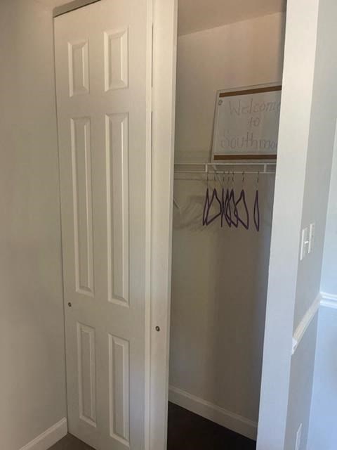 an empty closet with a white door