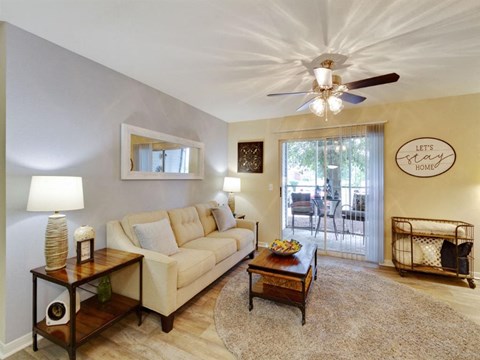 a living room with a couch and a ceiling fan