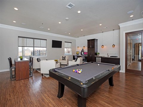 a pool table in the center of a living room