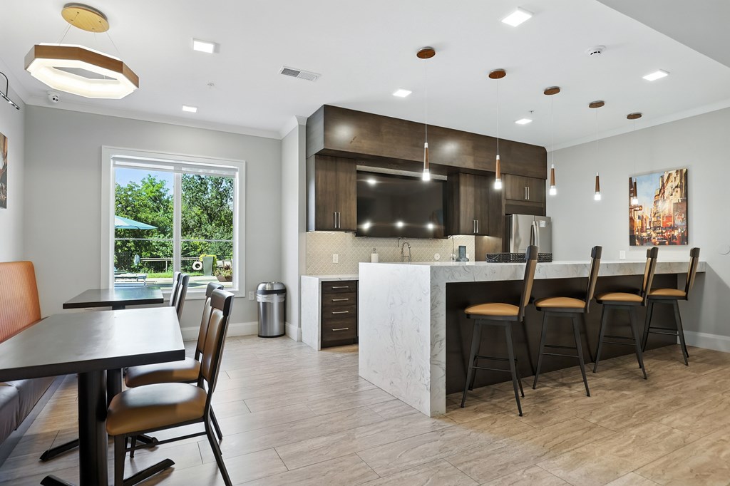 A modern kitchen with a dining table and chairs.