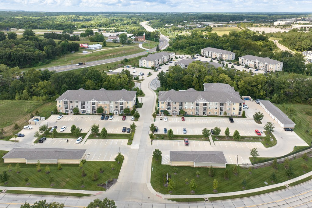 A large building complex with a parking lot in front.