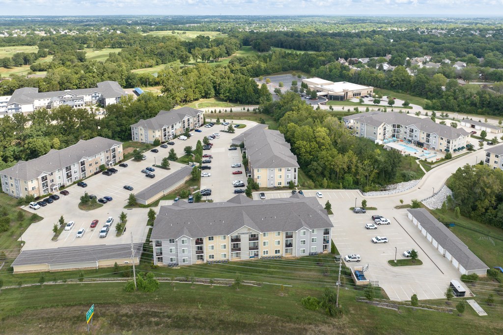 A large, modern apartment complex with multiple buildings and parking lots.