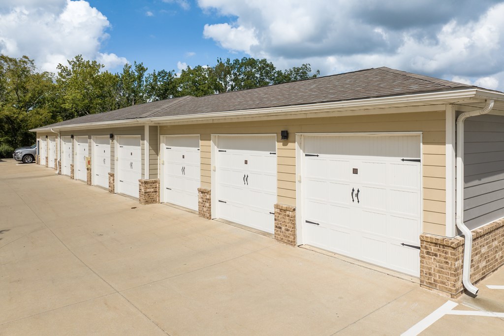 A row of white garage doors are closed.